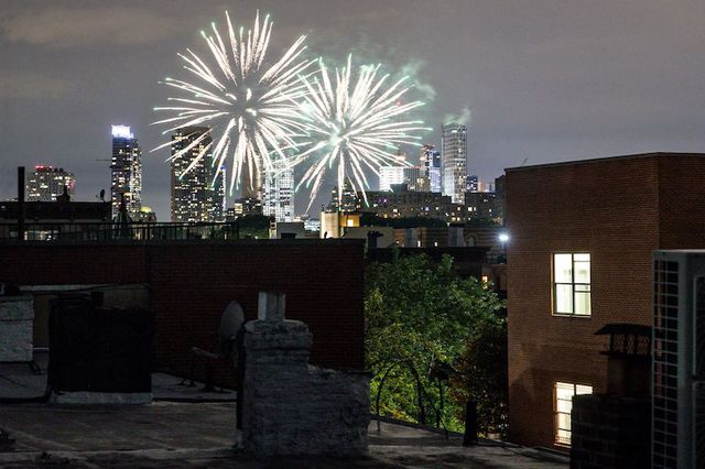 Fireworks explode against the backdrop of the Manhattan skyline above Bed-Stuy.